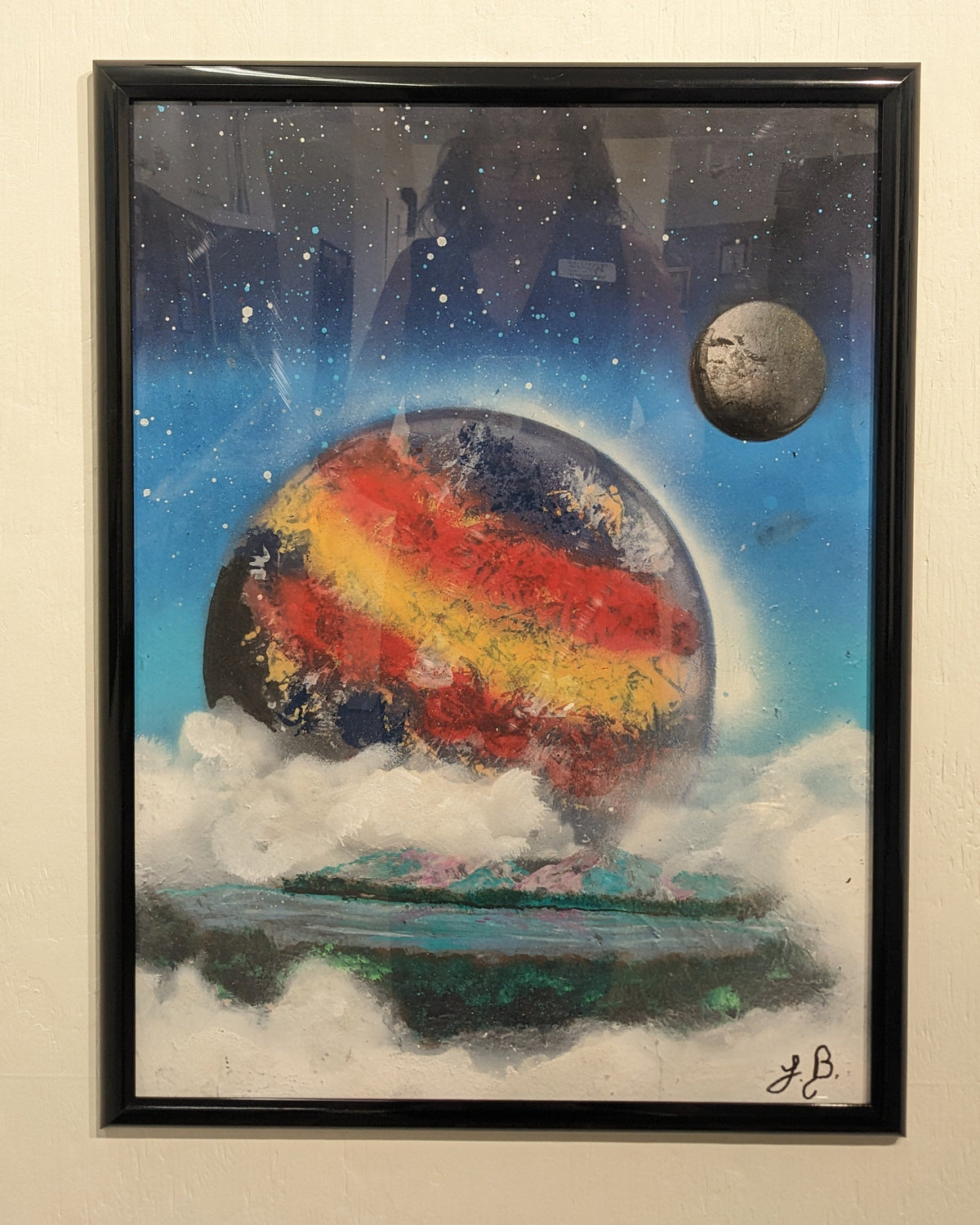 A piece of art features a blue, red and gold stripped planet circled by a moon viewed from a hazy horizon. 